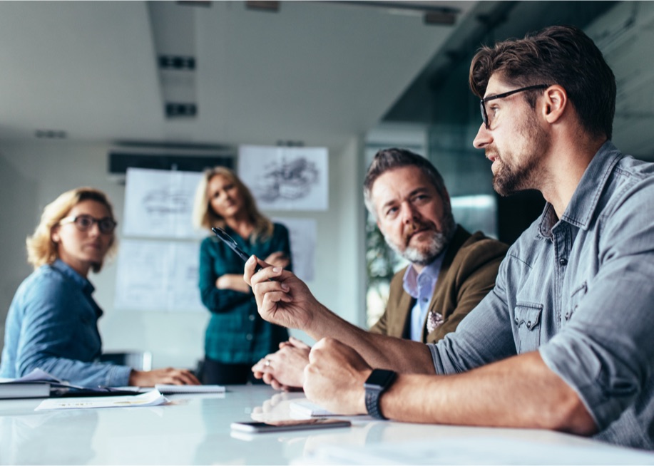 Team members discussing a project in a meeting room