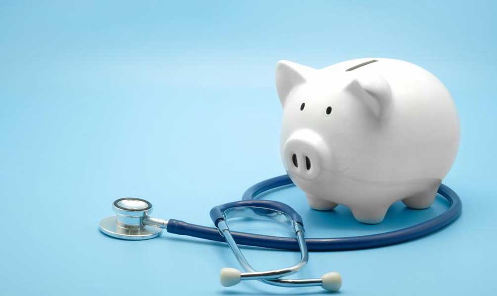 A white porcelain piggy bank with a blue stethoscope wrapped around it