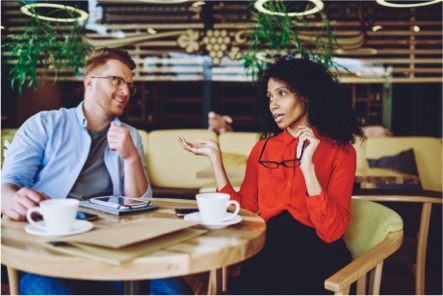 Two insurance brokers talking in a café booth