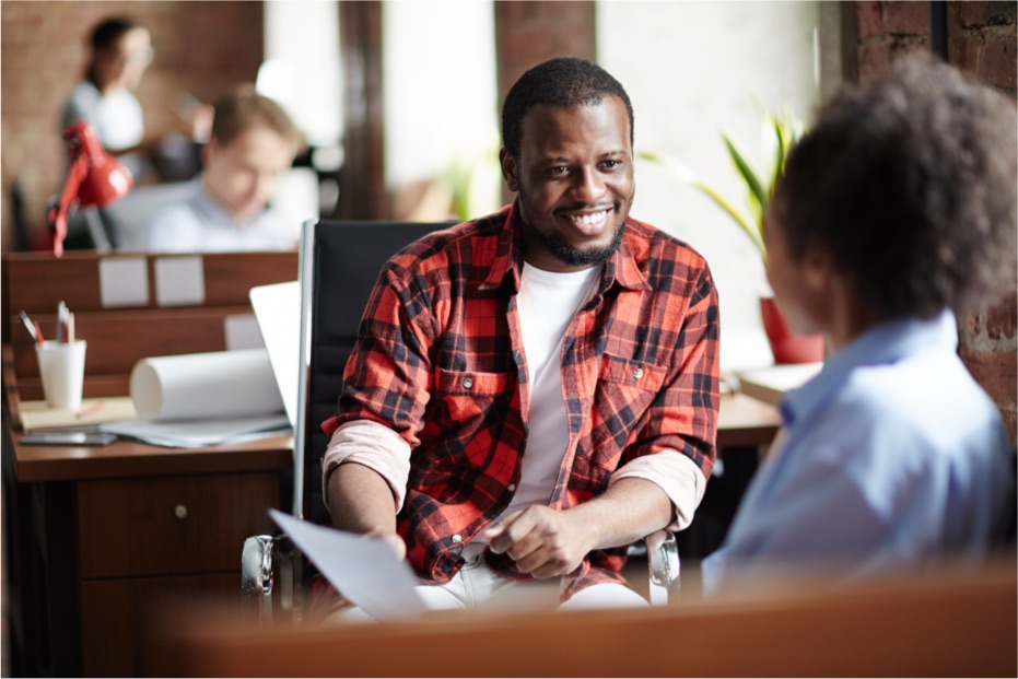 Two people looking over insurance benefits at a desk