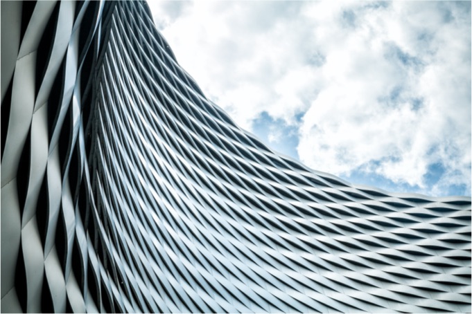 A metallic art structure with sheets of steel interecting each other and rising up