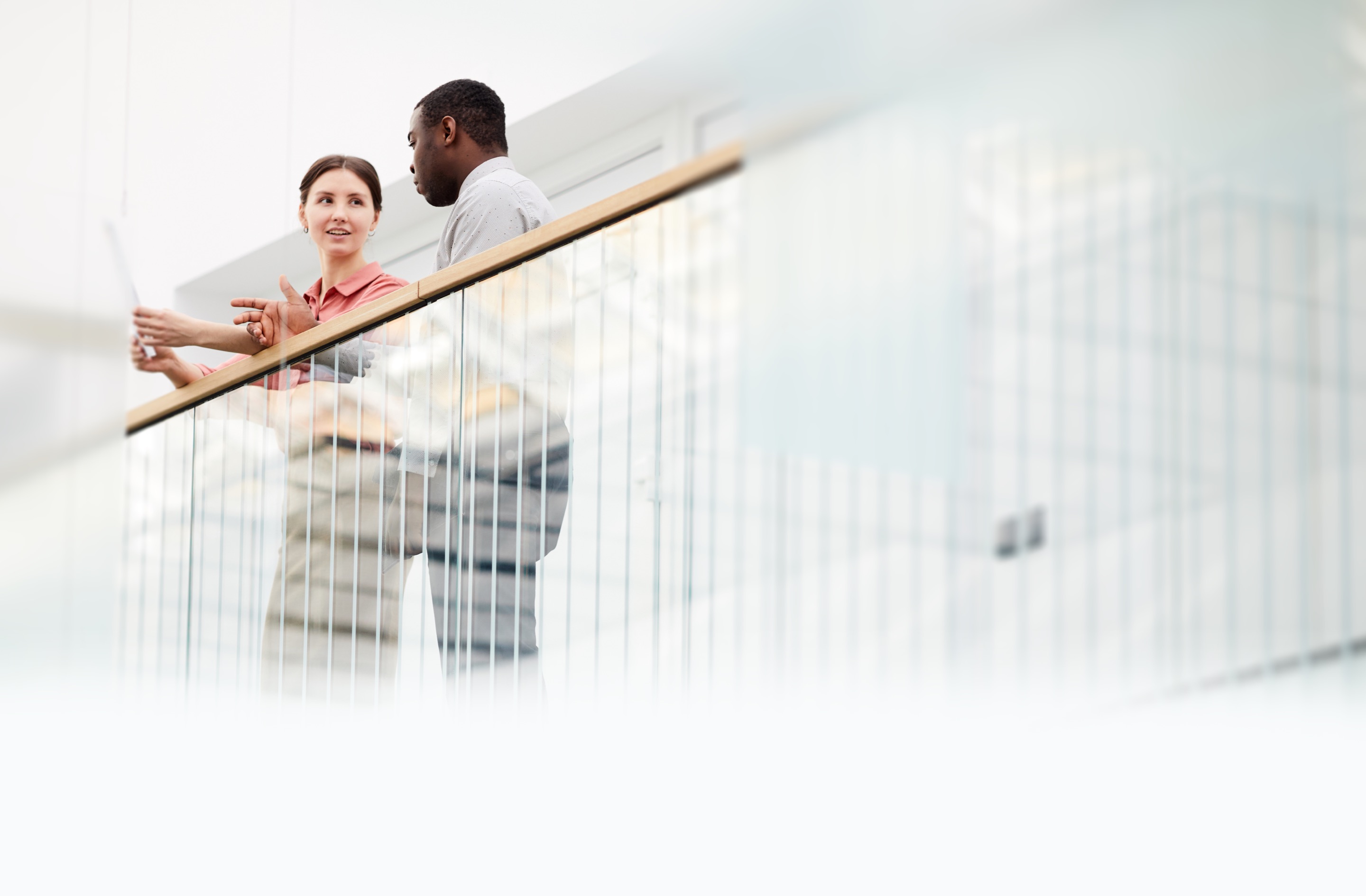 Man and woman standing near a balcony railing, talking about Panorama insurance